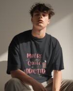 Sitting man wearing Black Iced Coffee Unisex Oversized T-Shirt